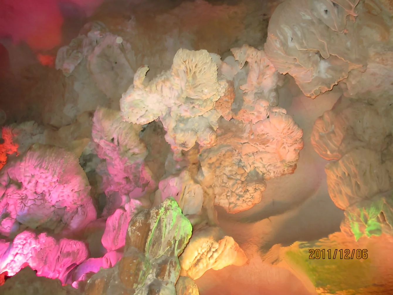 Colourful illuminated stalactites and rock formations inside a karst cave near Guilin, December 2011